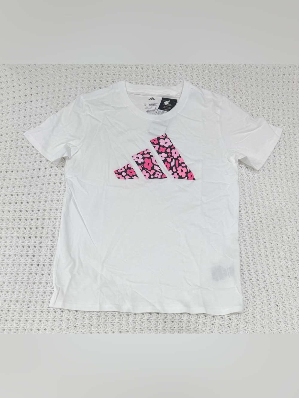 Adidas girls graphic t-shirt featuring a pink floral 3 bar logo in white size M.